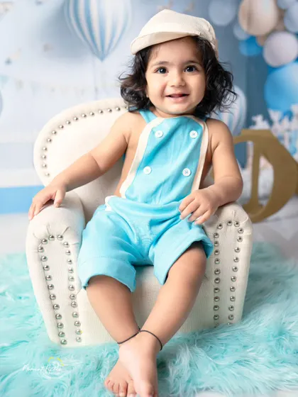 A sweet and simple portrait for a first birthday. This little guy's charming smile is the centerpiece of this lovely blue-themed studio session.