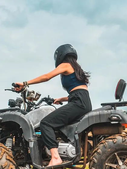 A side-view of a guest enjoying the power of our all-terrain vehicle. It's a great way to break the ice and get everyone in an adventurous spirit.