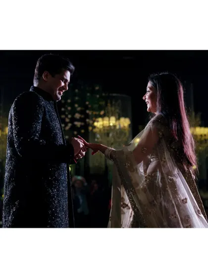 Aayush puts a ring on Saanya's finger during their engagement. The soft light and their happy expressions make this a classic and beautiful ring ceremony shot.