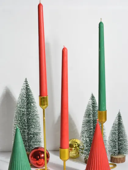 My elegant red and green taper candles in golden holders, perfect for a sophisticated Christmas dinner table setting.