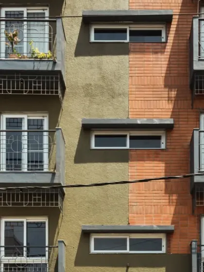 The facade of the Pixel 2 apartment building is a nod to Bengaluru's identity. We used locally sourced red bricks reminiscent of colonial architecture and a textured green plaster inspired by the "Garden City" tag. Each unit features a balcony with grills inspired by old bungalow gates, blending nostalgia with modern design.
