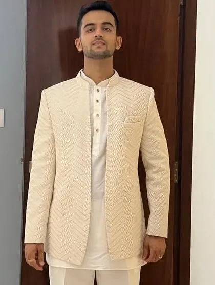 A full-length view of the cream Lakhnavi open Jodhpuri. The clean lines and detailed fabric make it a versatile piece for various pre-wedding functions.