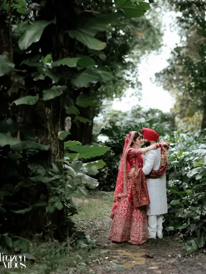 A romantic portrait in a lush, green forest. The natural surroundings create a beautiful, intimate setting for the couple's love story.