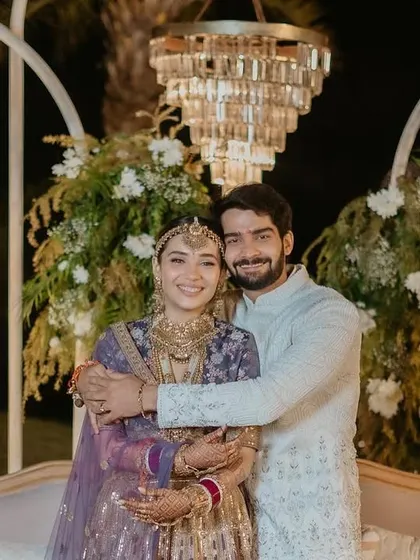 The happy couple at their 'Luxe Garden' reception. The backdrop of lush florals and modern chandeliers created a picture-perfect setting for their celebration.