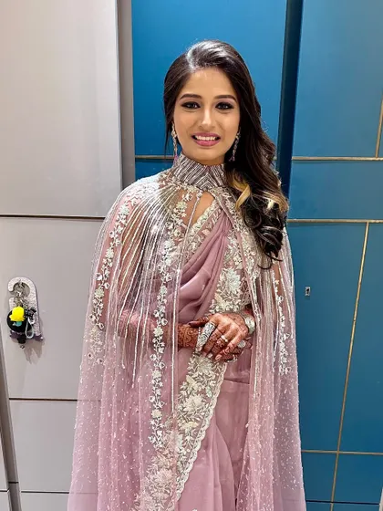 The full view of this captivating purple look, complete with a stunning cape saree.