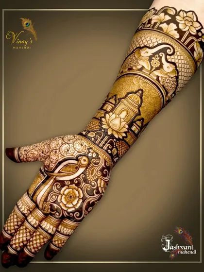 A close-up of the groom's sister's mehndi, showing a bird on the palm and a palace with a lotus on the forearm.