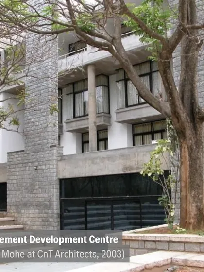The Management Development Centre at IIM-B (2003), where multi-level structures are integrated with existing trees and stone-clad towers.