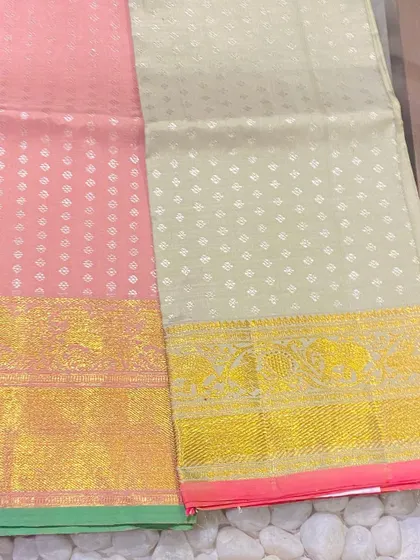 A lovely duo of pink and off-white Kanjeevaram blouse pieces. The fine butti work and traditional borders showcase the skilled craftsmanship.