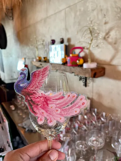 A custom-made peacock garnish for a wine glass. This was for a wedding with a royal theme, and these small details helped carry the theme through to the bar.