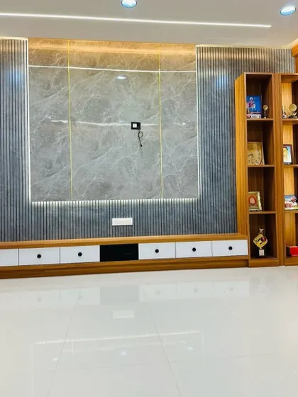 A full view of the TV and partition unit, showing how the elements come together. The design includes a low-lying console with white drawers for clean, concealed storage.