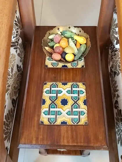 We love incorporating personal touches. This custom side table features beautiful Azulejos tiles brought back from Goa by our client, turning a simple piece of furniture into a treasured memory.