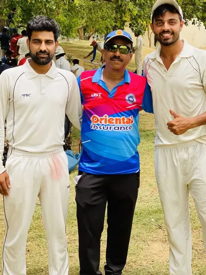 Teammates and a senior club member posing for a photo after a successful match. We are a close-knit community, from our youngest players to our most experienced mentors.
