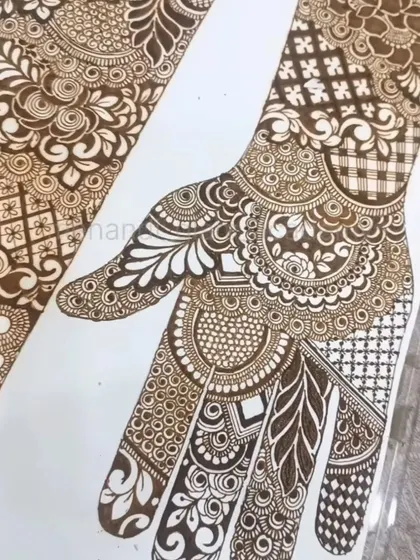 A full view of a practice sheet for an intricate bridal hand. Notice the mix of mandalas, leaf patterns, and checkered fillers we learn to combine.