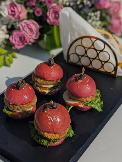 Attention to detail is key. These gourmet mini burgers with vibrant beetroot buns are an example of the creative and modern appetizers I craft to make your event's menu memorable and photo-worthy.