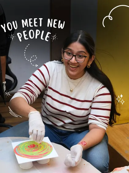 A student laughs with joy as she experiments with a fluid art technique. My workshops are social, fun, and a great way to meet new people.