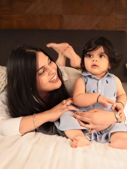 A mother and her baby share a smile during their cozy at-home lifestyle shoot. These sessions are all about capturing your real life in a beautiful way.