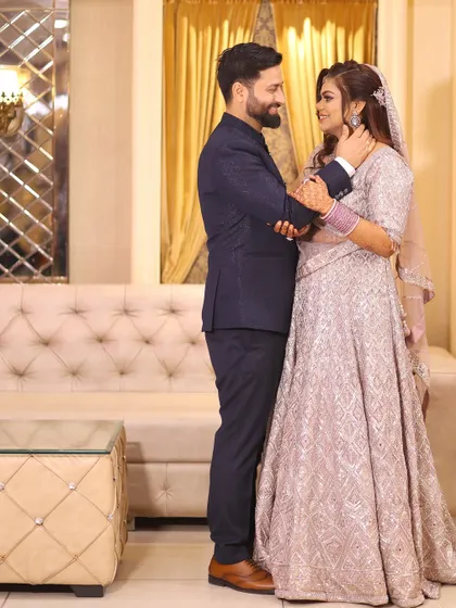A romantic portrait of the couple sharing a quiet moment, with the groom gently holding his bride's face.