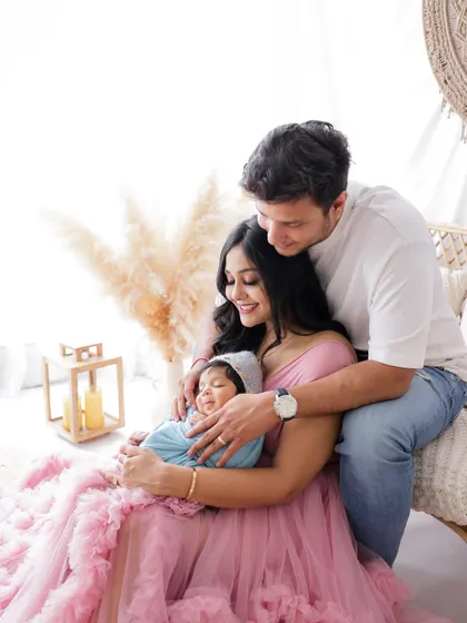 A duplicate of image 6, this photo shows the new parents filled with love and wonder as they hold their newborn for the first time.