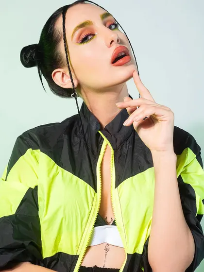 Embracing electric energy with this sporty, high-fashion look. I styled a neon and black windbreaker with fishnet stockings and bold makeup to create a vibrant and edgy aesthetic.