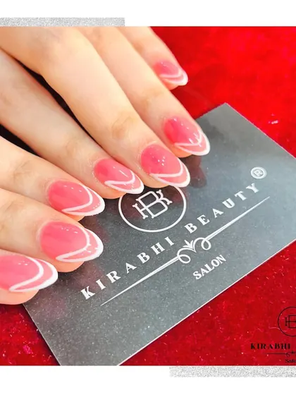 This design features a sheer pink base with a delicate, wavy white line accentuating the tip. It's a simple, elegant, and modern nail art style.