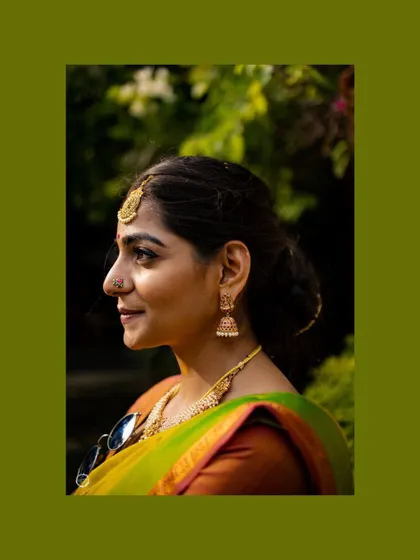 A profile shot of Nithyashri showing her natural-looking makeup and simple, elegant hairstyle. My goal is always to make you feel like the best version of yourself.