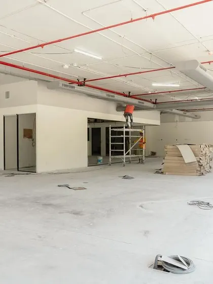 An image of a project in its early construction phase. The space is a blank canvas, with structural work and initial partitioning underway.