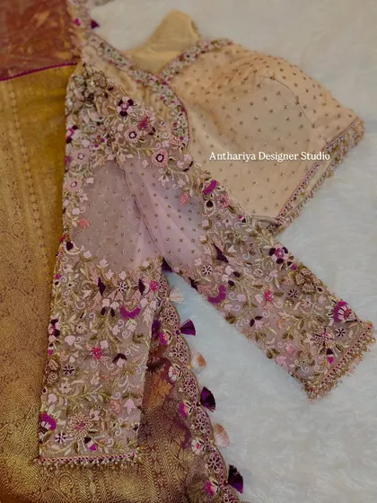 A close-up of the floral embroidery on the sheer sleeves.