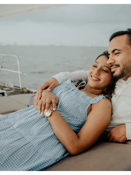 A tender moment of rest during a pre-wedding yacht shoot, showing the couple's comfortable and easy love.