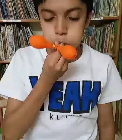 A student demonstrates how air pressure works using a simple balloon experiment. Our workshops are filled with these small, impactful moments of discovery.