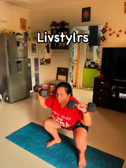 A client performs a goblet squat with a heavy dumbbell, demonstrating significant strength and excellent form.