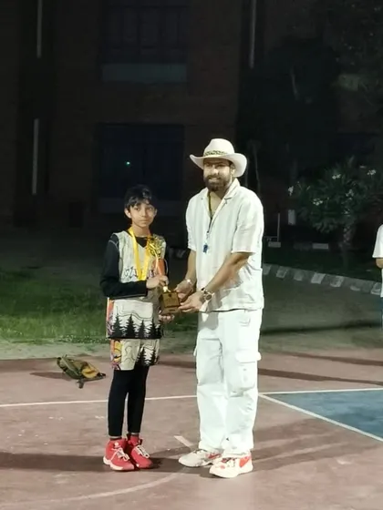 A moment of pride as a young player receives his trophy.