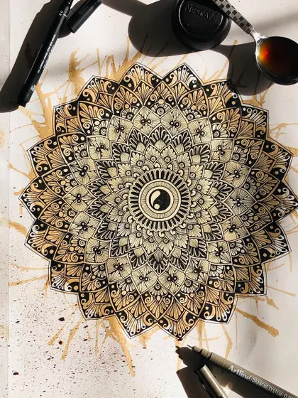 An experimental piece from my sketchbook, where I used coffee to stain the paper and create a warm, vintage effect behind the ink mandala.