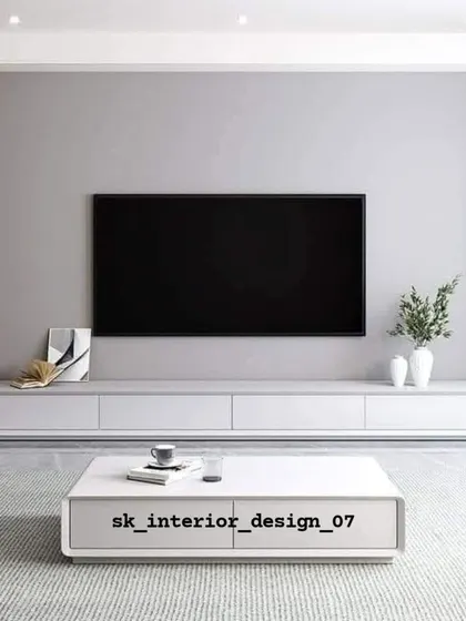 A minimalist TV setup with a low-profile white console and matching coffee table. This design emphasizes clean lines and is perfect for a modern, uncluttered aesthetic.
