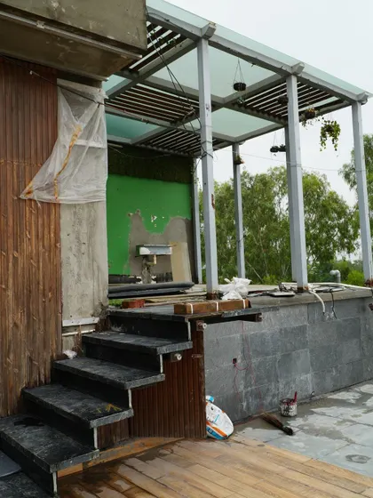 A work-in-progress shot of the jacuzzi and pergola area on the Pitampura terrace. This image captures the construction phase before the final finishes, lighting, and greenery are added.