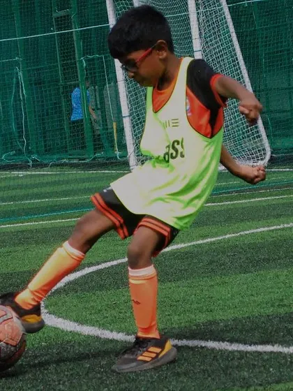 This U-9 player is focused on his kick during a training drill. Repetition and practice are key to mastering the fundamentals of football.