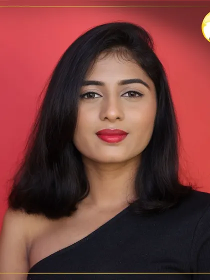 This close-up highlights the perfect application of the red lipstick and the clean lines of the eyeliner. The skin is kept fresh and natural to balance the bold lip.