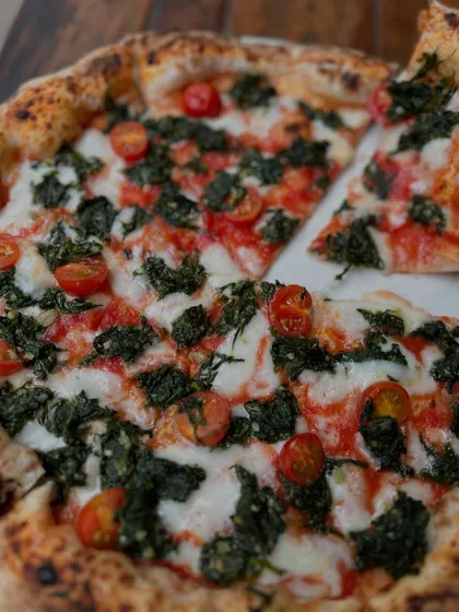 No frills, just flavour. Our Spinach and Garlic pizza is simple, bold, and ridiculously good, topped with fresh spinach, garlic, and cherry tomatoes.