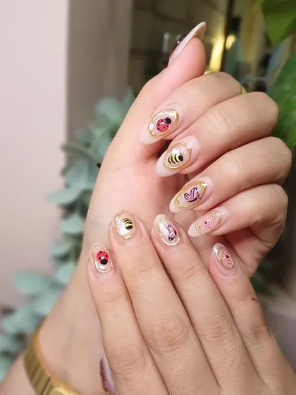 The almond shape of the nails provides the perfect canvas for these adorable, hand-painted characters.