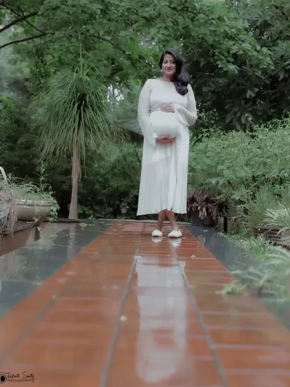 This low-angle shot creates a powerful and dramatic portrait. The reflection on the wet path adds a beautiful artistic element to the composition.