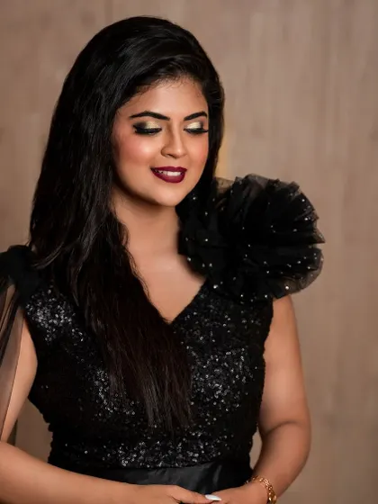 A throwback photoshoot with actress Mansi Joshi. This dramatic look features a bold smokey eye and a deep red lip, paired with a stunning black gown.