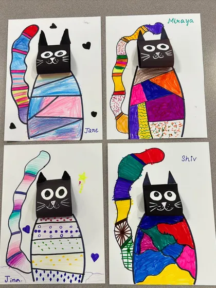 A collection of the patterned cats. Each one has a unique "sweater" design and a colourful tail.