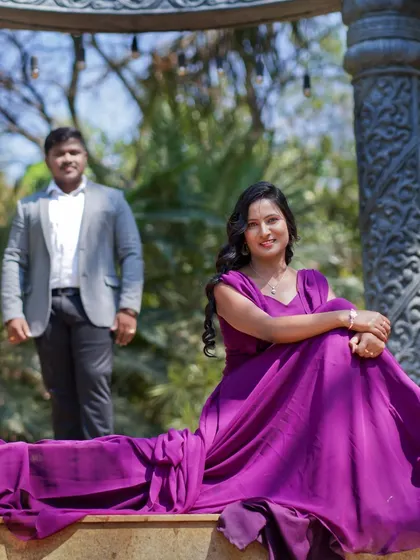 A beautiful portrait of the bride-to-be during her pre-wedding shoot, with her flowing purple gown arranged艺术fully on the steps.
