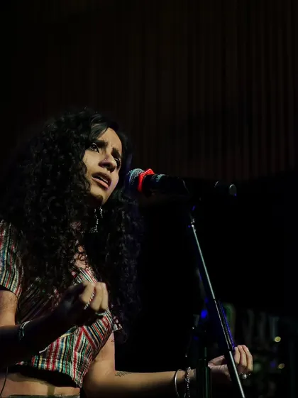 A powerful shot of singer Bawari Basanti mid-performance. Her expressive face and posture convey the passion and emotion she brings to her music, typical of the artists we feature.