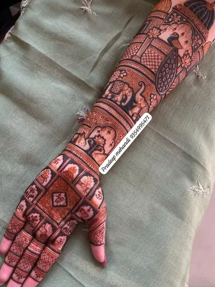 The full view of the arm, showing how the different traditional elements like elephants, peacocks, and geometric patterns come together to create a cohesive design.