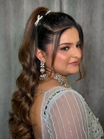 A side profile of the Bandoli look, highlighting the sharp ponytail and elegant earrings.