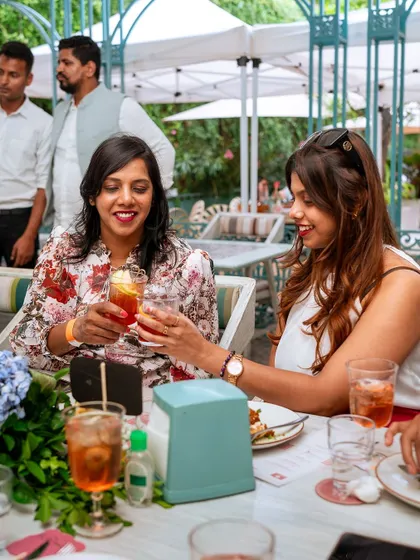 A toast between friends during a sunlit brunch event. My outdoor spaces are perfect for daytime celebrations and social gatherings.