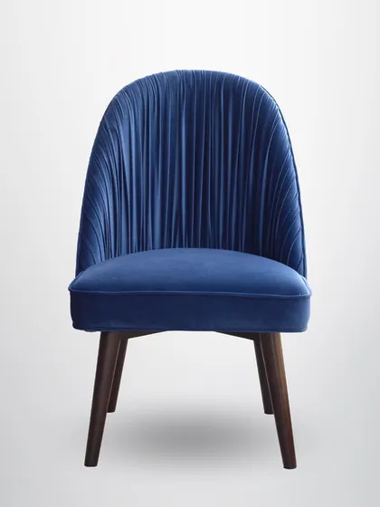 The front view of the pleated chair shows its simple, comfortable seat, which allows the detailed back to be the star.