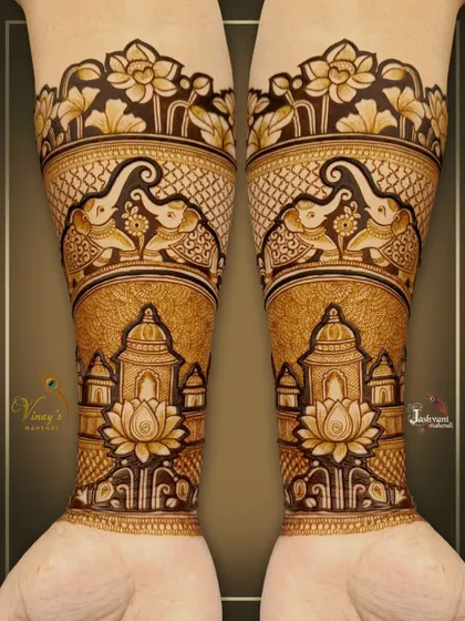 A symmetrical design for the groom's sister, featuring elephants and lotus flowers on the arms, with palace architecture near the wrists.
