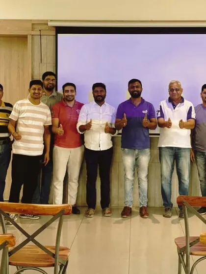 A group of committee members gives a thumbs-up after a successful meeting with our team.
