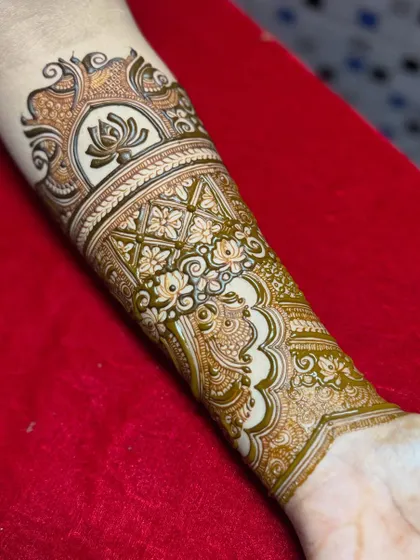 The design is nearly complete, with flowing paisley elements connecting the main sections. This step focuses on ensuring the entire piece has a natural and beautiful flow on the arm.